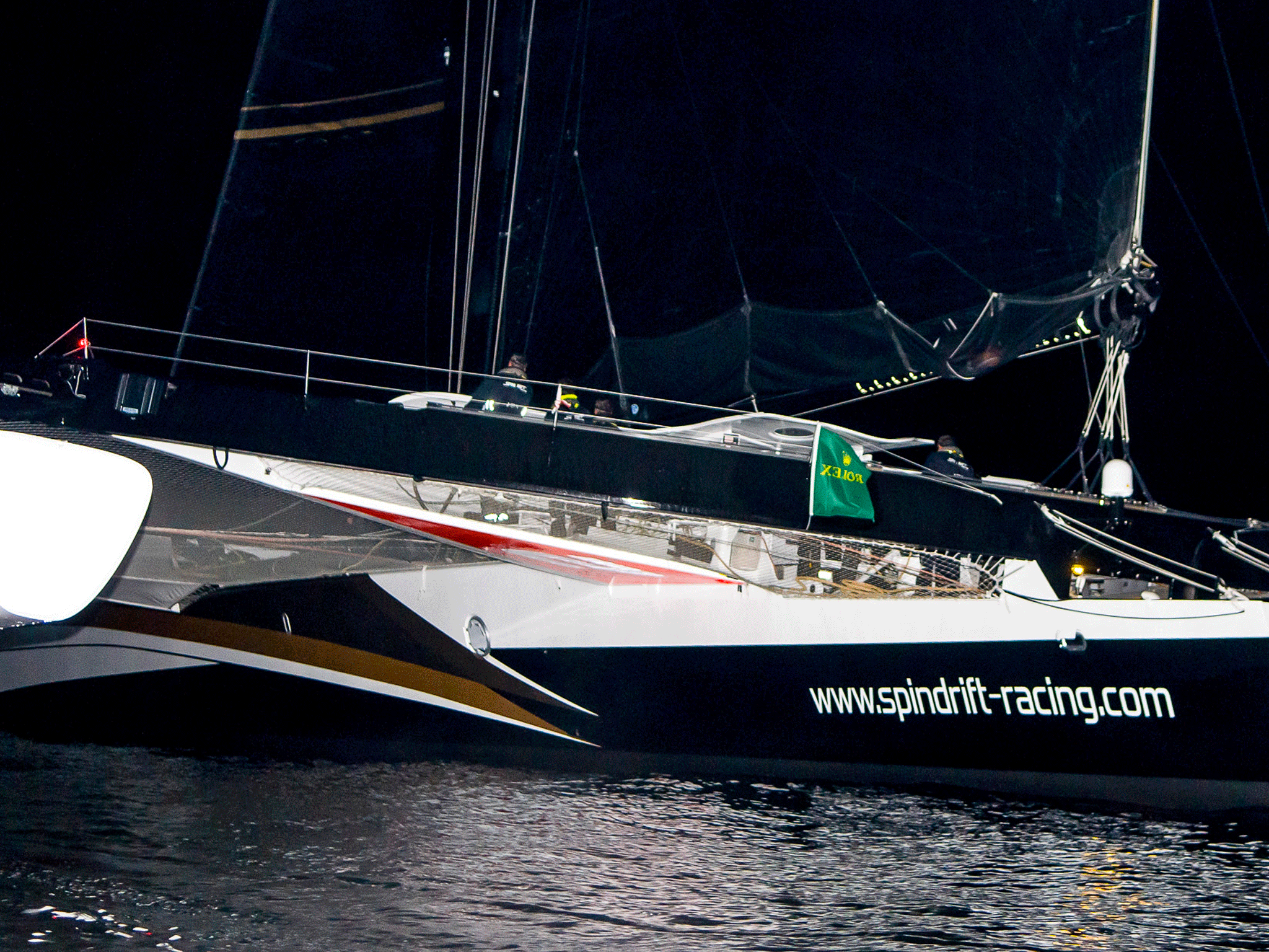First home. The Swiss-owned 131-foot trimaran Spindrift, co-skippered by Dona Bertarelli and Yann Guichard, ghosts across the finish line off the breakwater in Plymouth having completed the 611-mile Rolex Fastnet Race from Cowes in 38hr 53min 58sec.