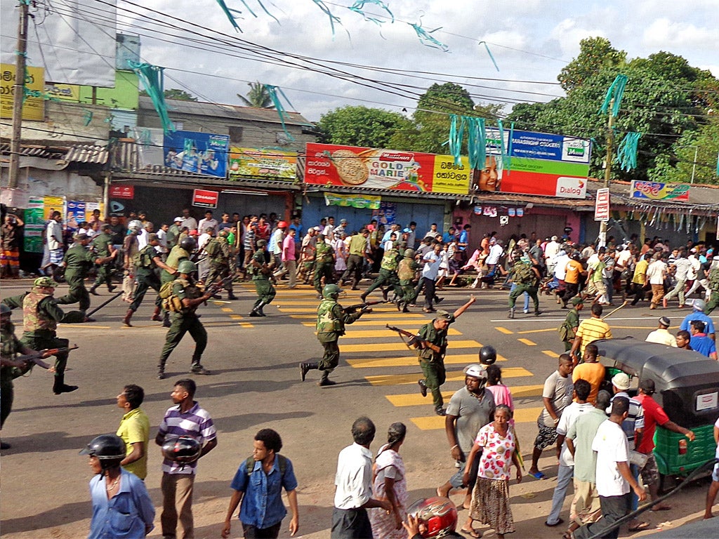 Sri Lankan troops chase local residents protesting against the alleged poisoning of drinking water in the village of Weliweriya in August