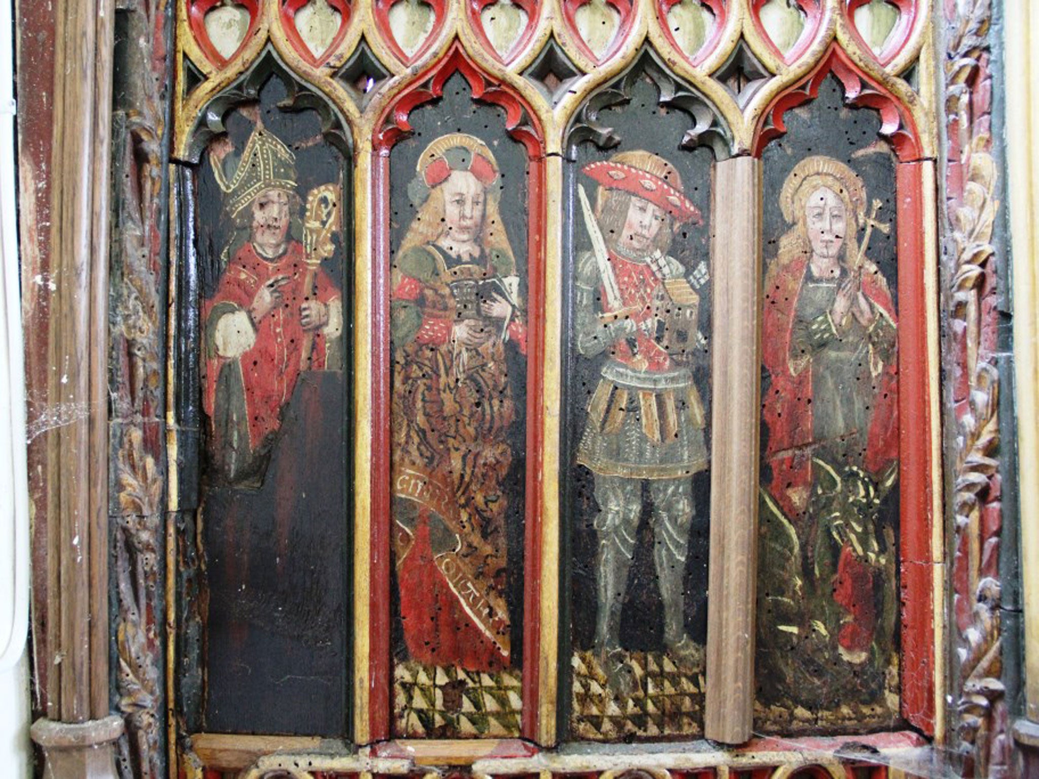 Thieves have hacked out two 15th century panels from a screen in The Holy Trinity Church in Torbryan, Devon.