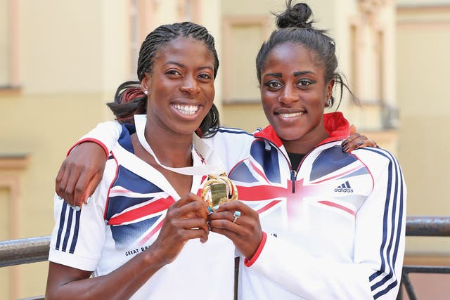Christine Ohuruogu (left) poses yesterday with her gold medal and sister Vicky, who is part of the relay squad in Moscow
