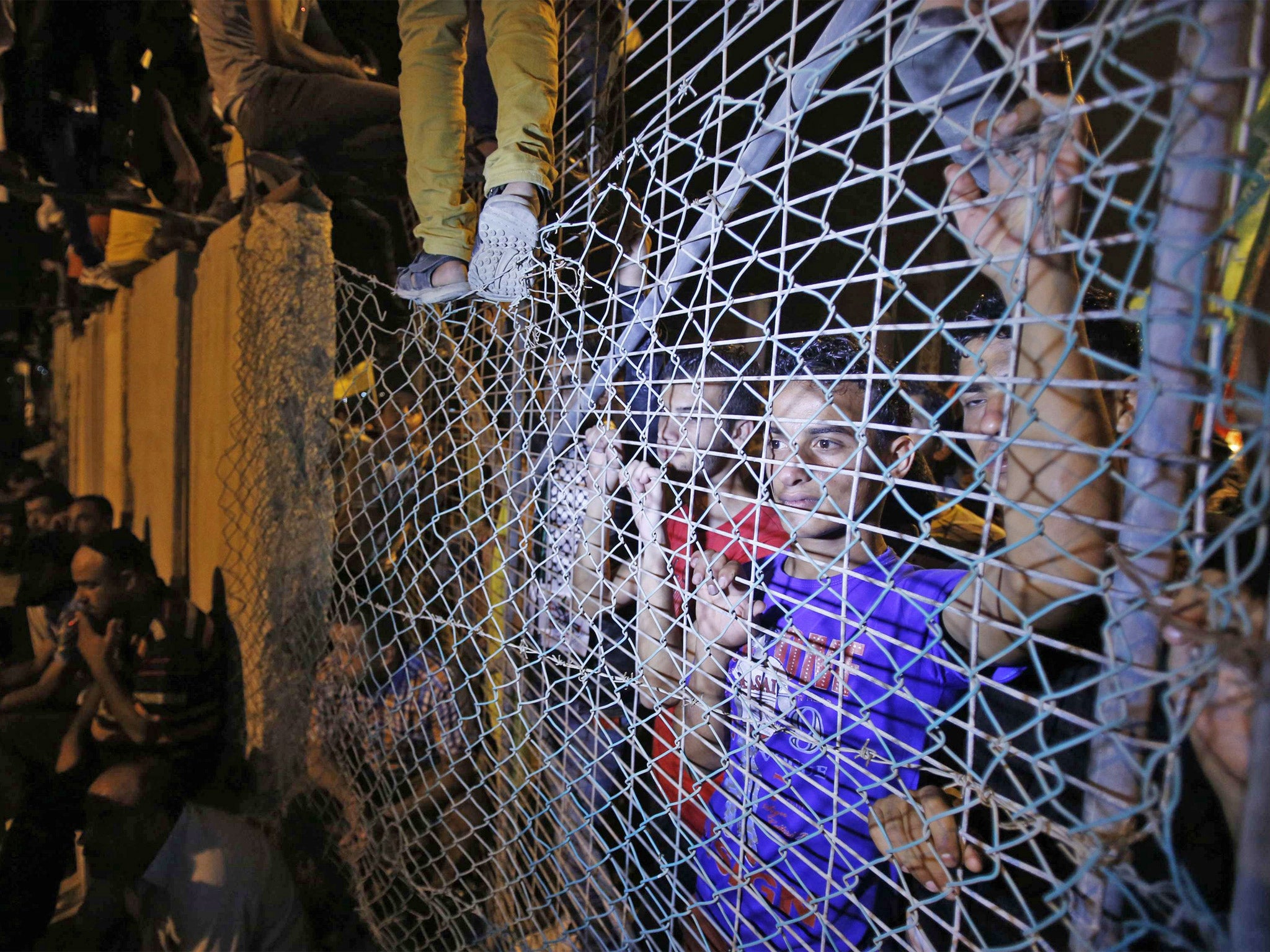 People wait near the Erez crossing between Israel and the Gaza Strip for the arrival of Palestinian prisoners released from Israeli jails on Tuesday