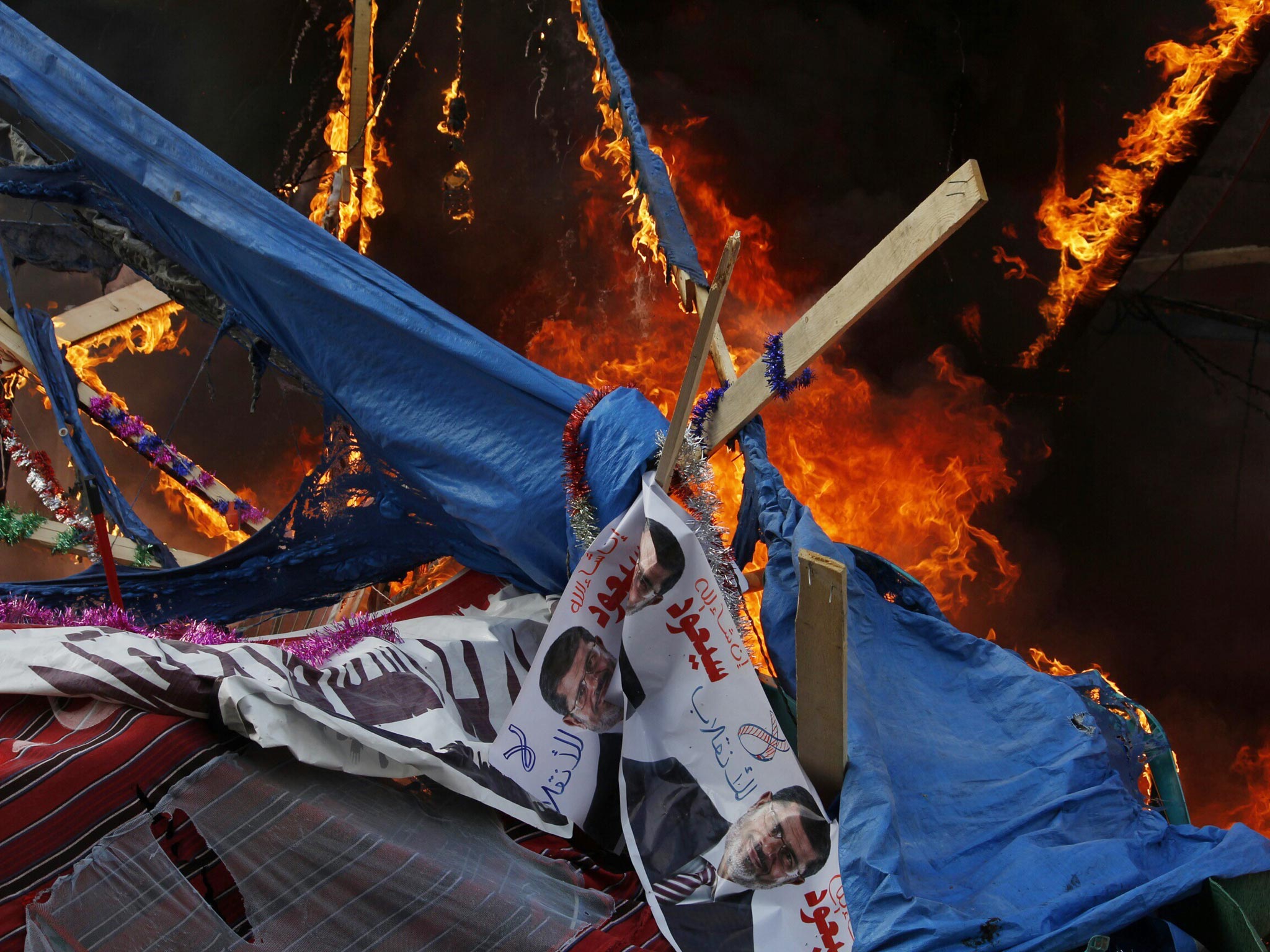 A fire rages in a protest tent as Egyptian security forces moved in to disperse supporters