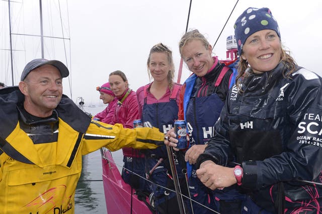 Honours nearly even for the two Volvo 70s in their Rolex Fastnet Race head to head as Abu Dhabi skipper Ian Walker (GBR left), first home, greets Sam Davies (GBR right) ahead on handicap in the Swedish Team SCA. Pictured centre, left to right, are Sarah L