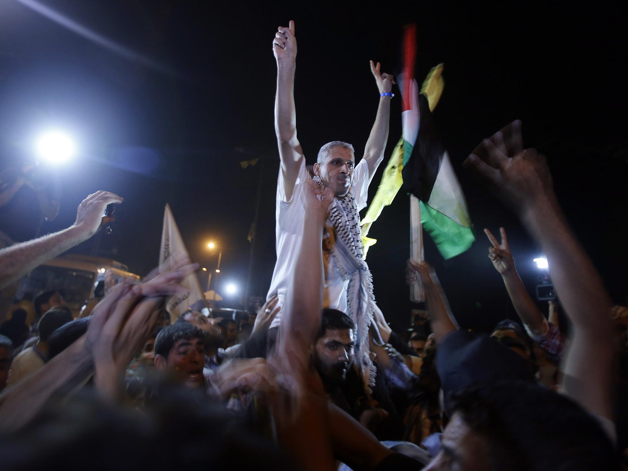 A freed Palestinian prisoner gestures upon his arrival