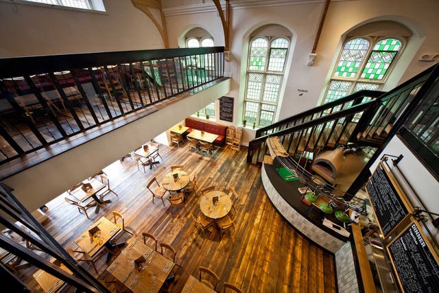 The River Cottage Canteen occupies a converted church hall, with vaulted ceilings and tall stained-glass windows, and a mezzanine