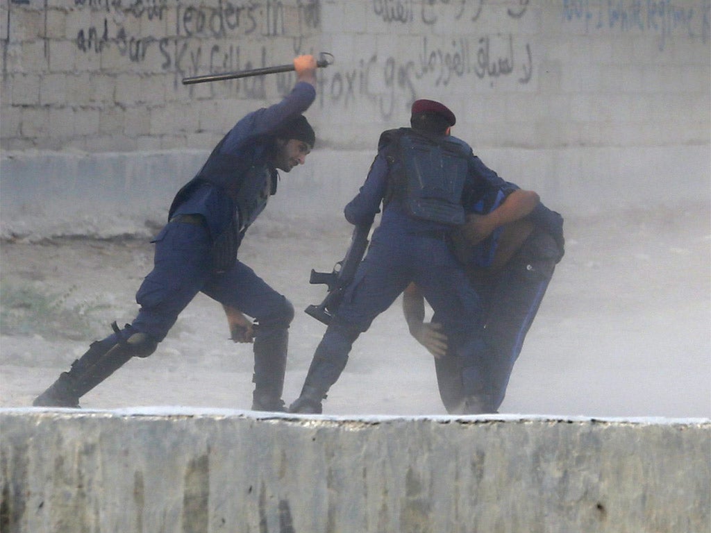 Riot police detain an anti-government protester during clashes in the village of Shakhoora