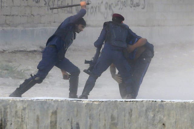 Riot police detain an anti-government protester during clashes in the village of Shakhoora