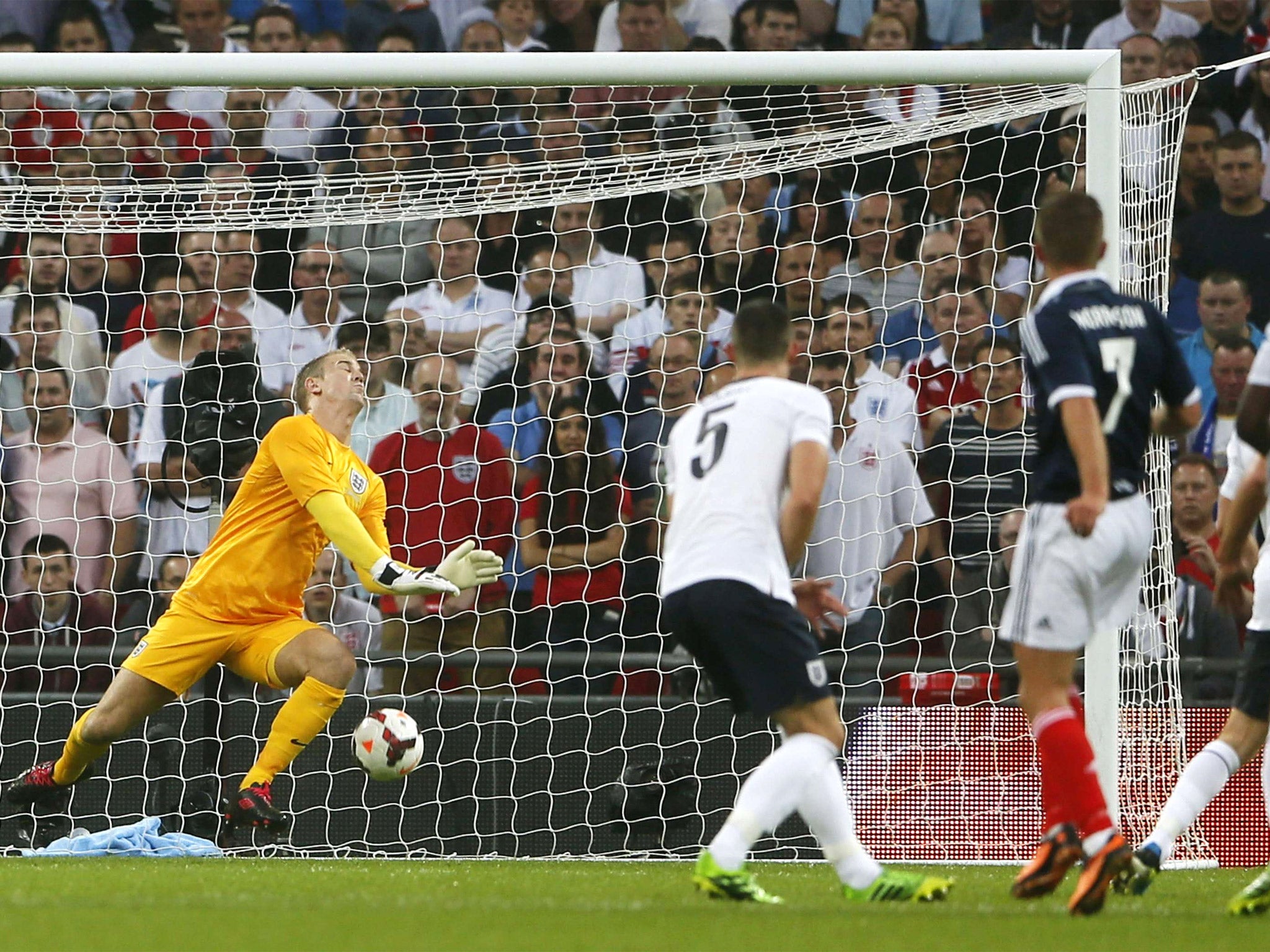 Joe Hart is at fault as he fails to save the shot from James Morrison (right) which brought Scotland’s first goal