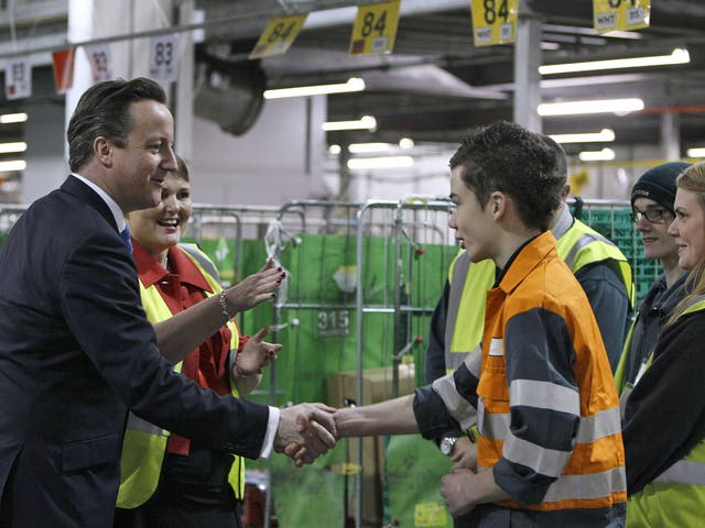 David Cameron shakes hands with a young apprentice  during a visit to Waitrose