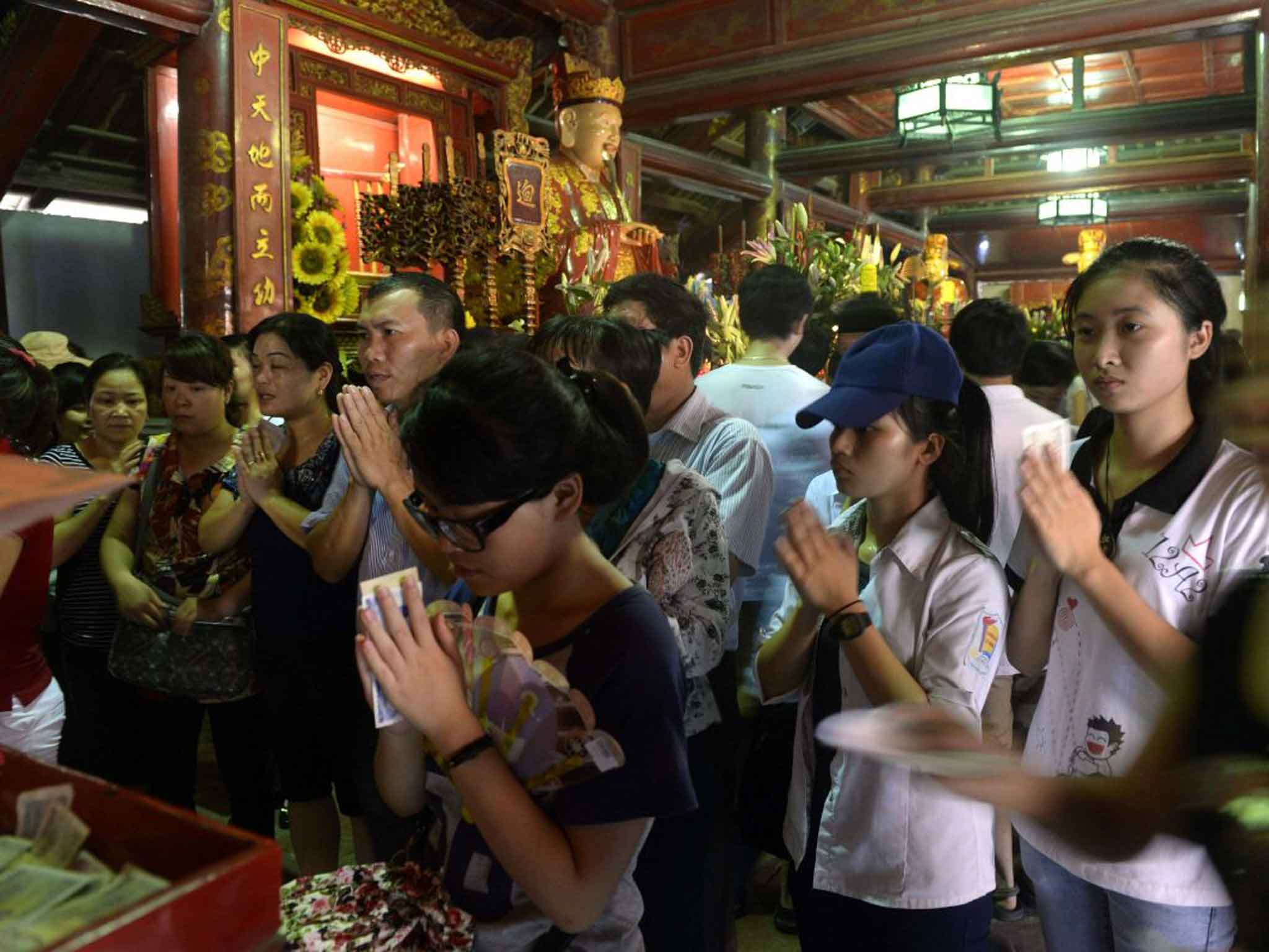Students praying for luck before exams at a Vietnam university