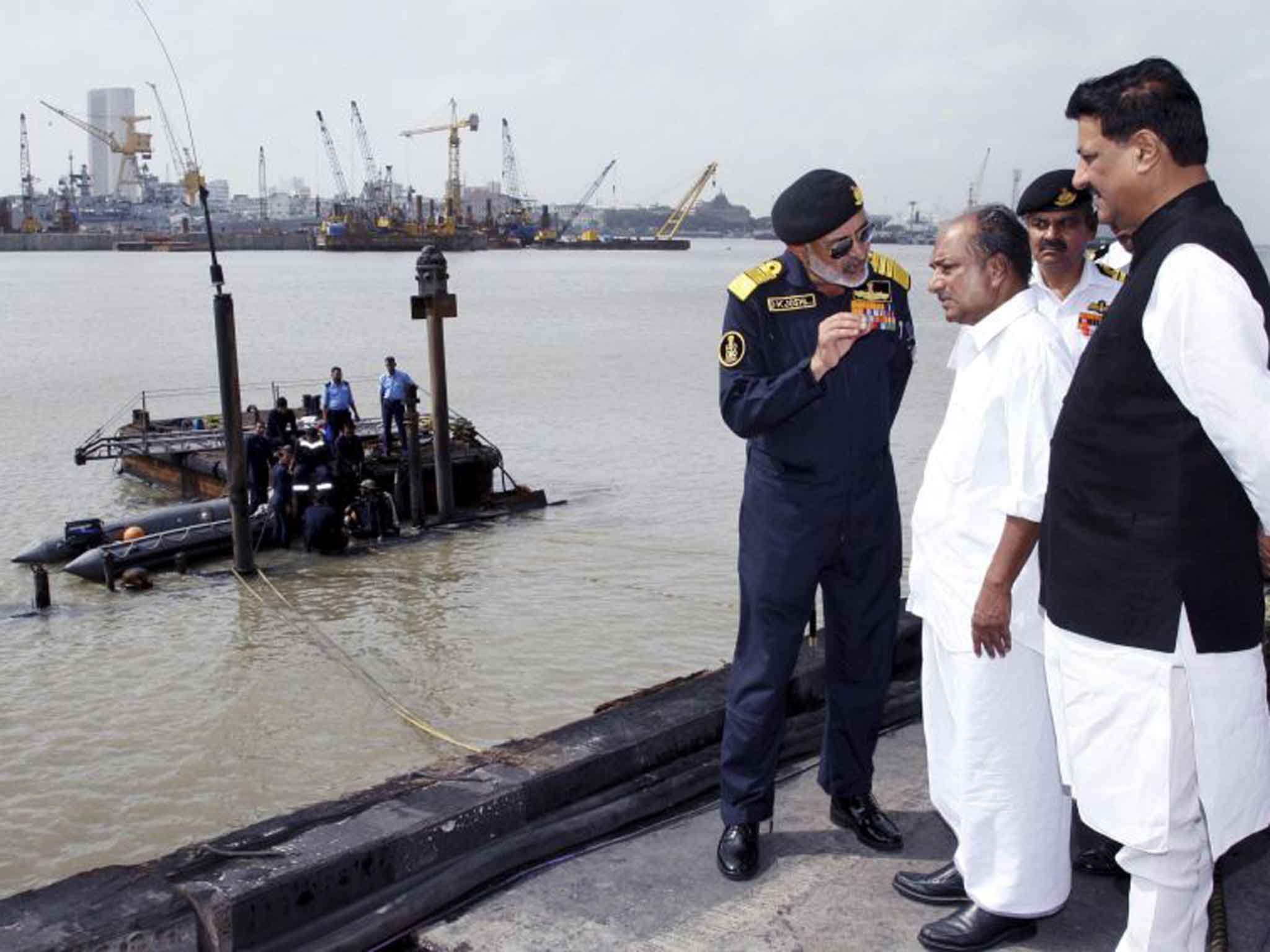 Admiral Joshi, left, meets India’s Defence Minister A K Antony, second left, by the sunken submarine