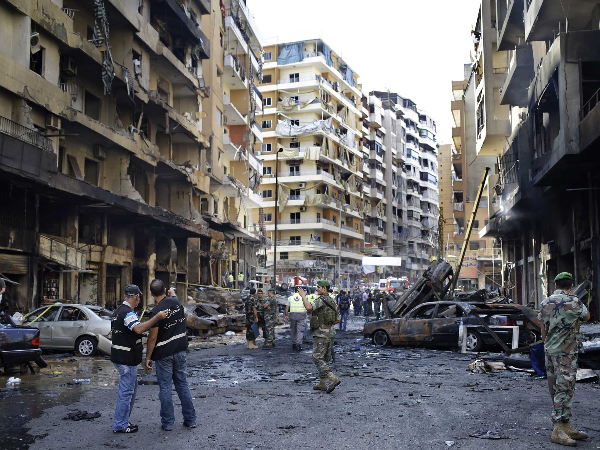 Lebanese army investigators inspect the site of a car bomb explosion