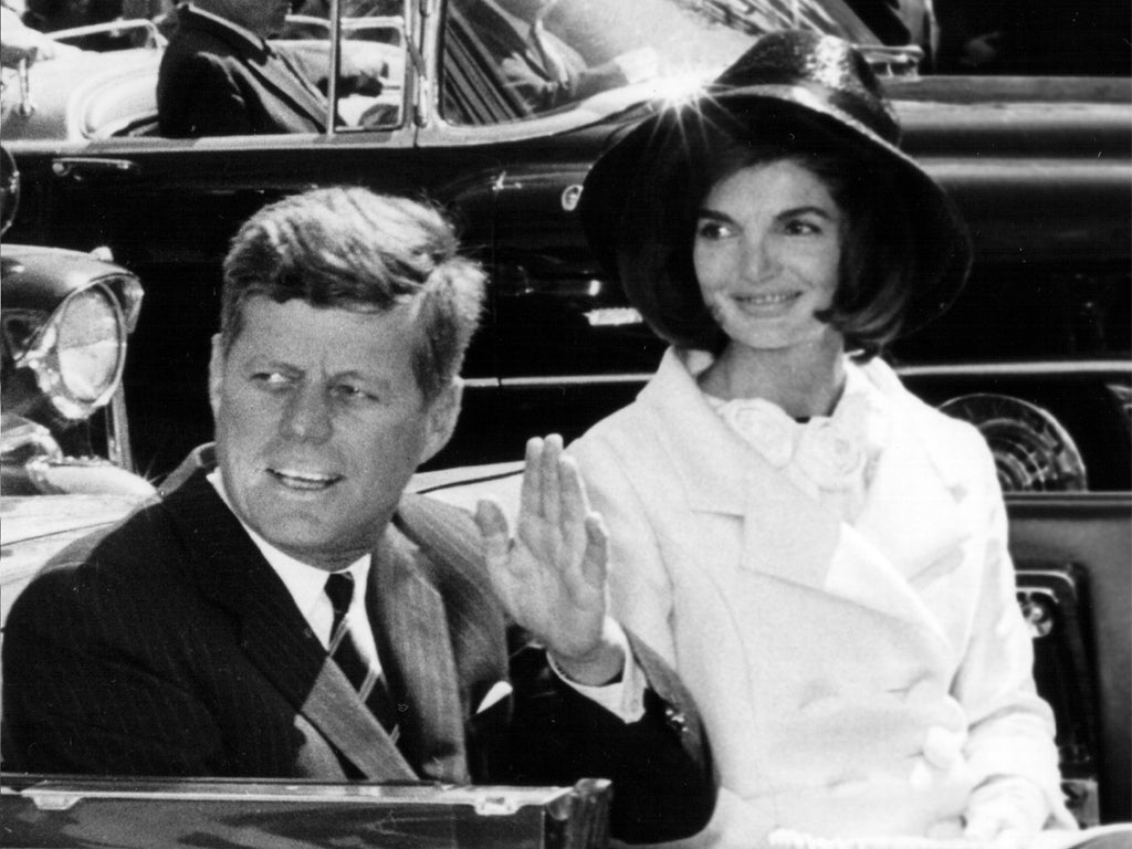 The President and Mrs Kennedy often travelled in an open car so that they could greet huge crowds
