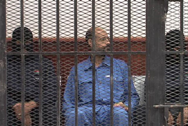 Saif al-Islam Gaddafi in a defendant’s cage in a courtroom in Zintan