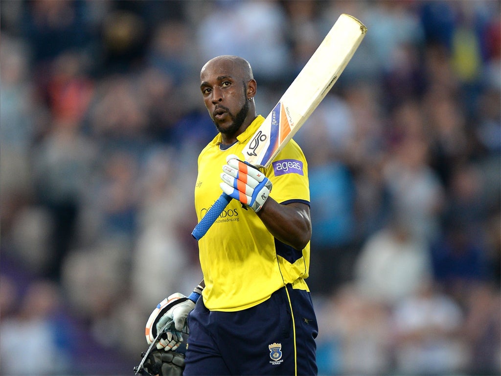 Michael Carberry raises his bat to the crowd as he leaves the field of play