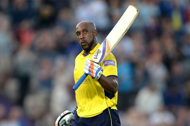 Michael Carberry raises his bat to the crowd as he leaves the  field of play