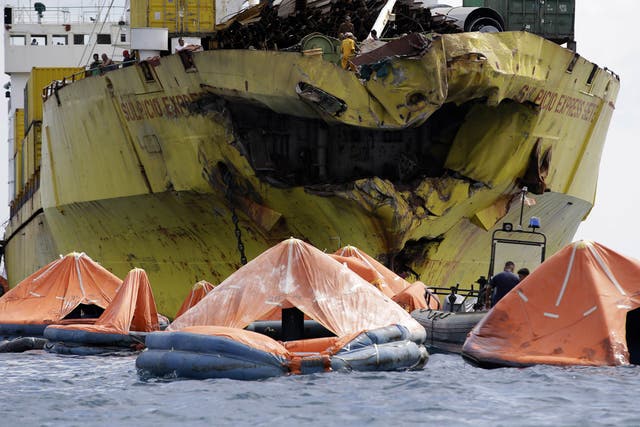Life rafts in front of the holed cargo ship