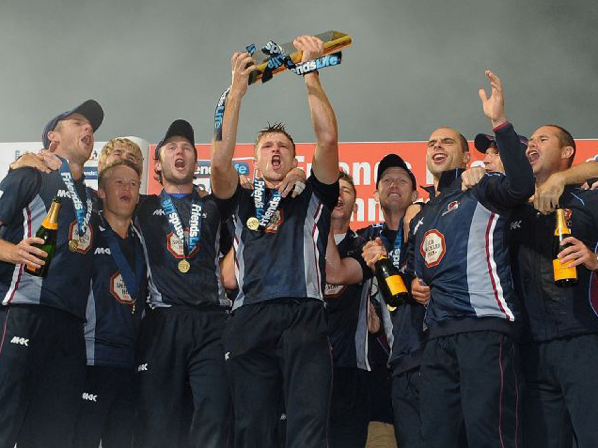 Northamptonshire celebrate, with David Willey holding the trophy, after a comprehensive win over Surrey