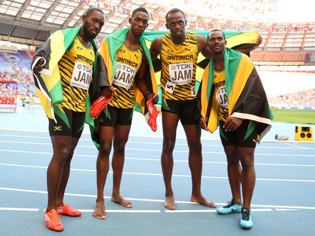 Usain Bolt (second from right), celebrates with Jamaican 4x100m team-mates (left to right) Nickel Ashmeade, Kemar Bailey-Cole, and Nesta Carter 