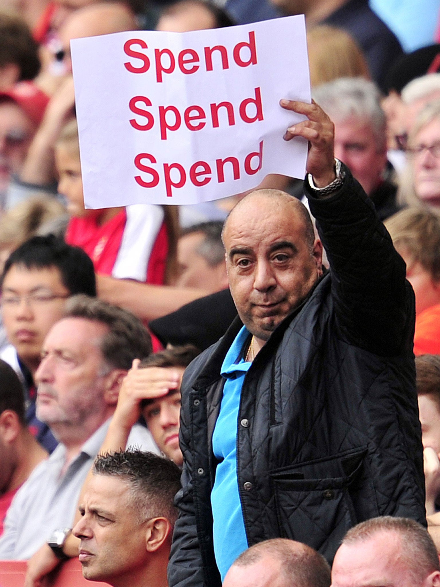 An Arsenal fan makes his feelings clear to Arsène Wenger
