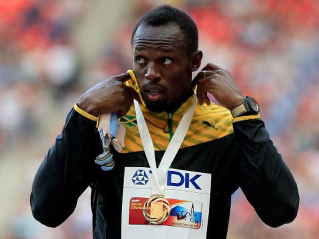 Usain Bolt on the podium with his third gold of the Championships and eighth gold at the Worlds overall (Jamie Squire/Getty Images)