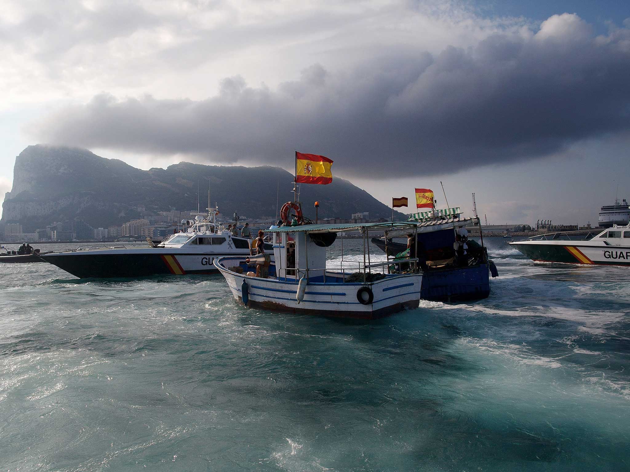 A Gibraltar police boat, Spanish Guardia Civil boat and Spanish fishing boats sail during a protest by Spanish fishermen in the sea near the Spain/Gibraltar border