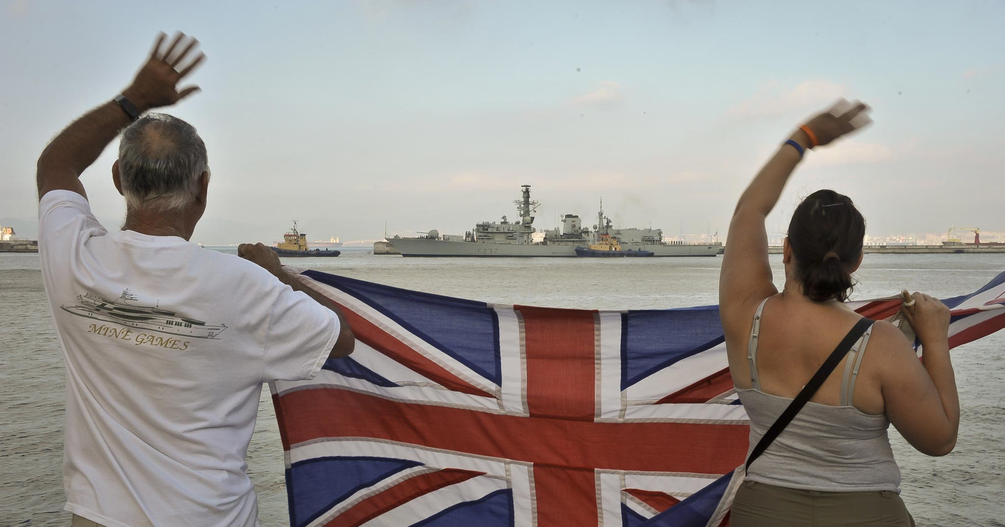 Gibraltarians wave Union Flags as the Royal Navy warship HMS Westminster arrives into the harbour at Gibraltar for a scheduled visit ahead of exercises in the Mediterranean.