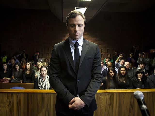 Murder accused Oscar Pistorius (C) appears in the Pretoria Magistrates court in Pretoria, South Africa