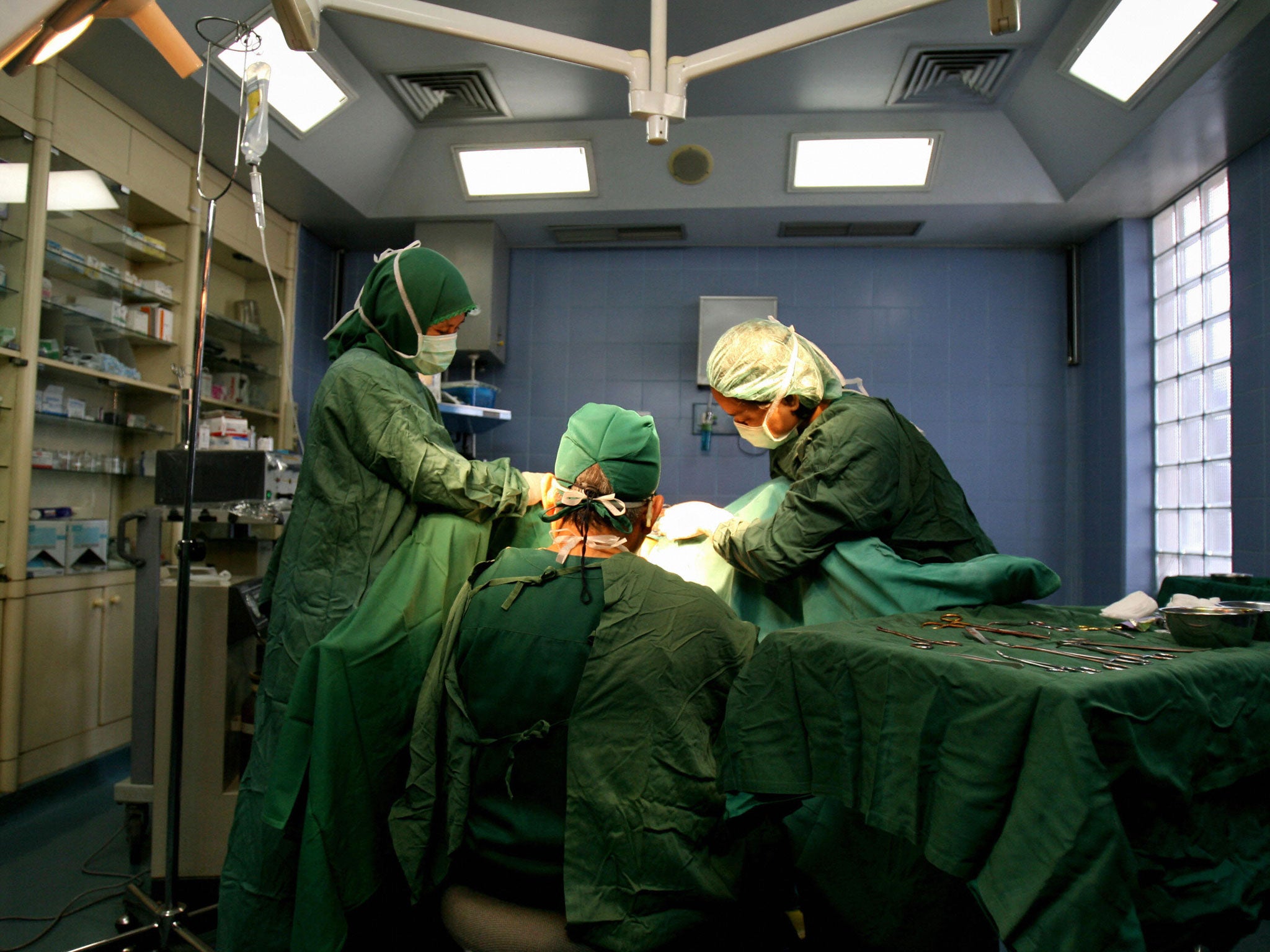 Doctors conduct a vagina surgery on a patient at a private clinic in Jakarta, 13 June 2007.