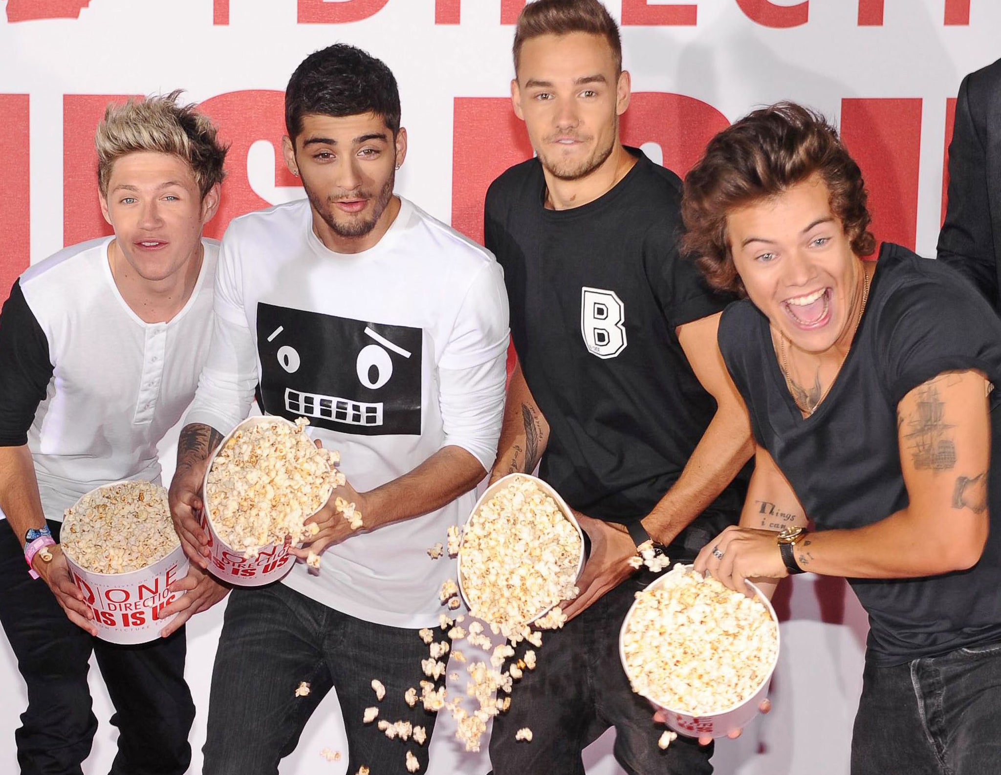 One Direction boys Niall Horan, Zayn Malik, Liam Payne and Harry Styles throwing popcorn at the launch of Morgan Spurlock's new documentary This Is Us