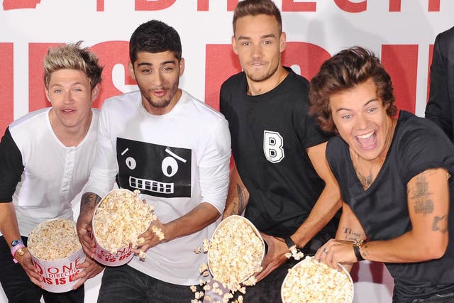 One Direction boys Niall Horan, Zayn Malik, Liam Payne and Harry Styles throwing popcorn at the launch of Morgan Spurlock's new documentary This Is Us