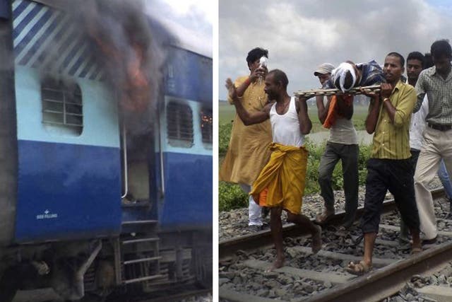 Coaches of the Rajya Rani Express train burn after a mob set it on fire as it ran over a group of Hindu pilgrims in Bihar state, India. And right, villagers carry away an injured person 