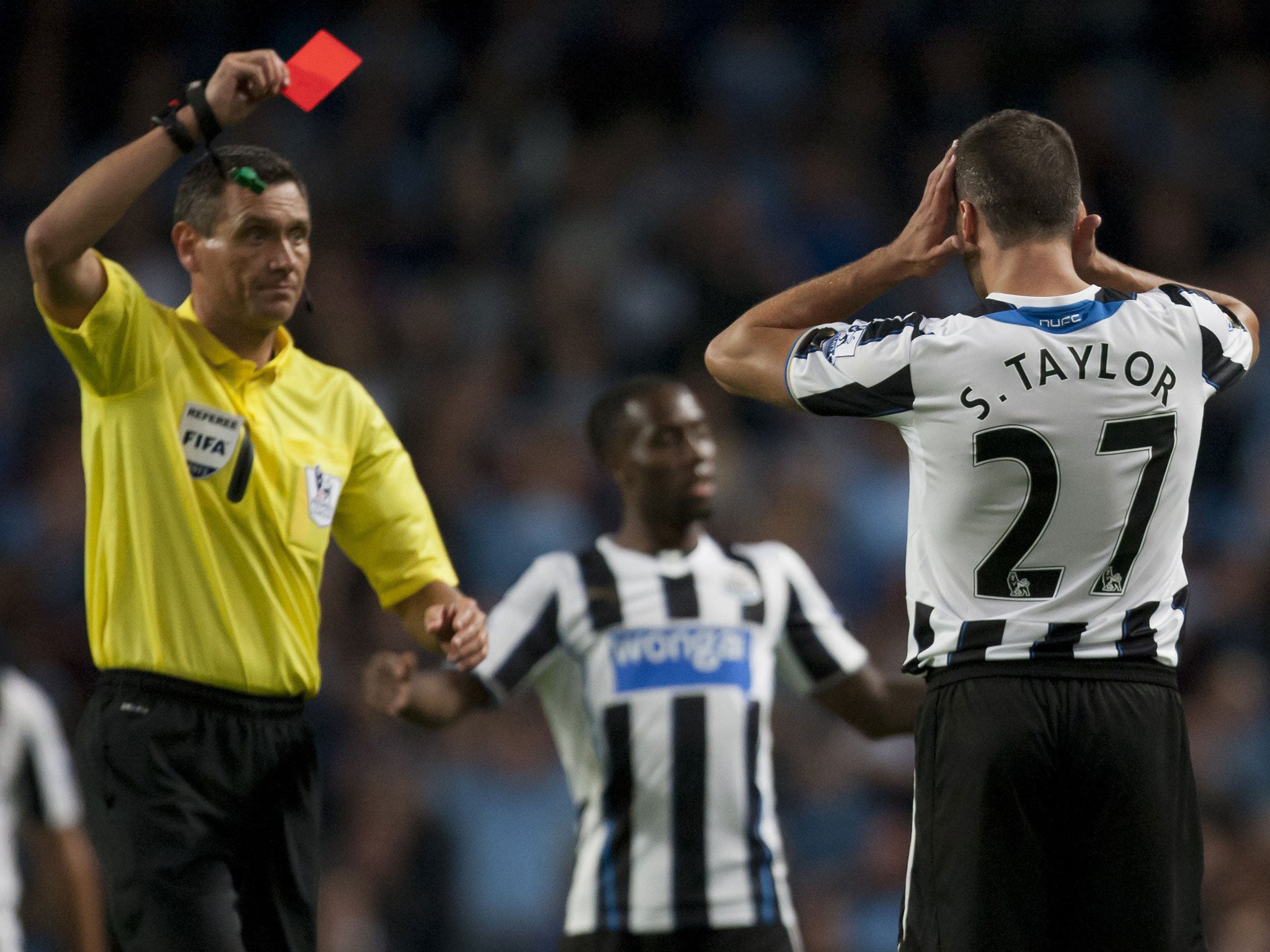 Newcastle's Steven Taylor is shown a straight red card last night
