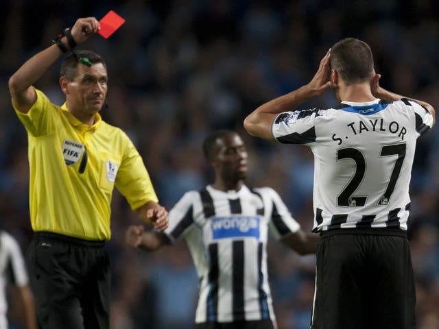 Newcastle's Steven Taylor is shown a straight red card last night 