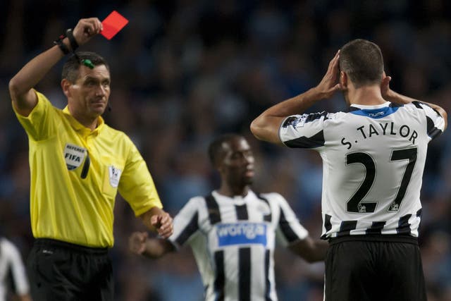 Newcastle's Steven Taylor is shown a straight red card last night 