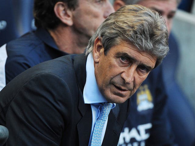 City manager Manuel Pellegrini looks on with satisfaction from the City bench