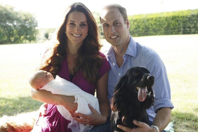 The photo taken by Michael Middleton, the Duchess's father, of the Duke and Duchess of Cambridge as they sit with their son Prince George and cocker spaniel Lupo in the garden of the Middleton family home in Bucklebury, Berkshire