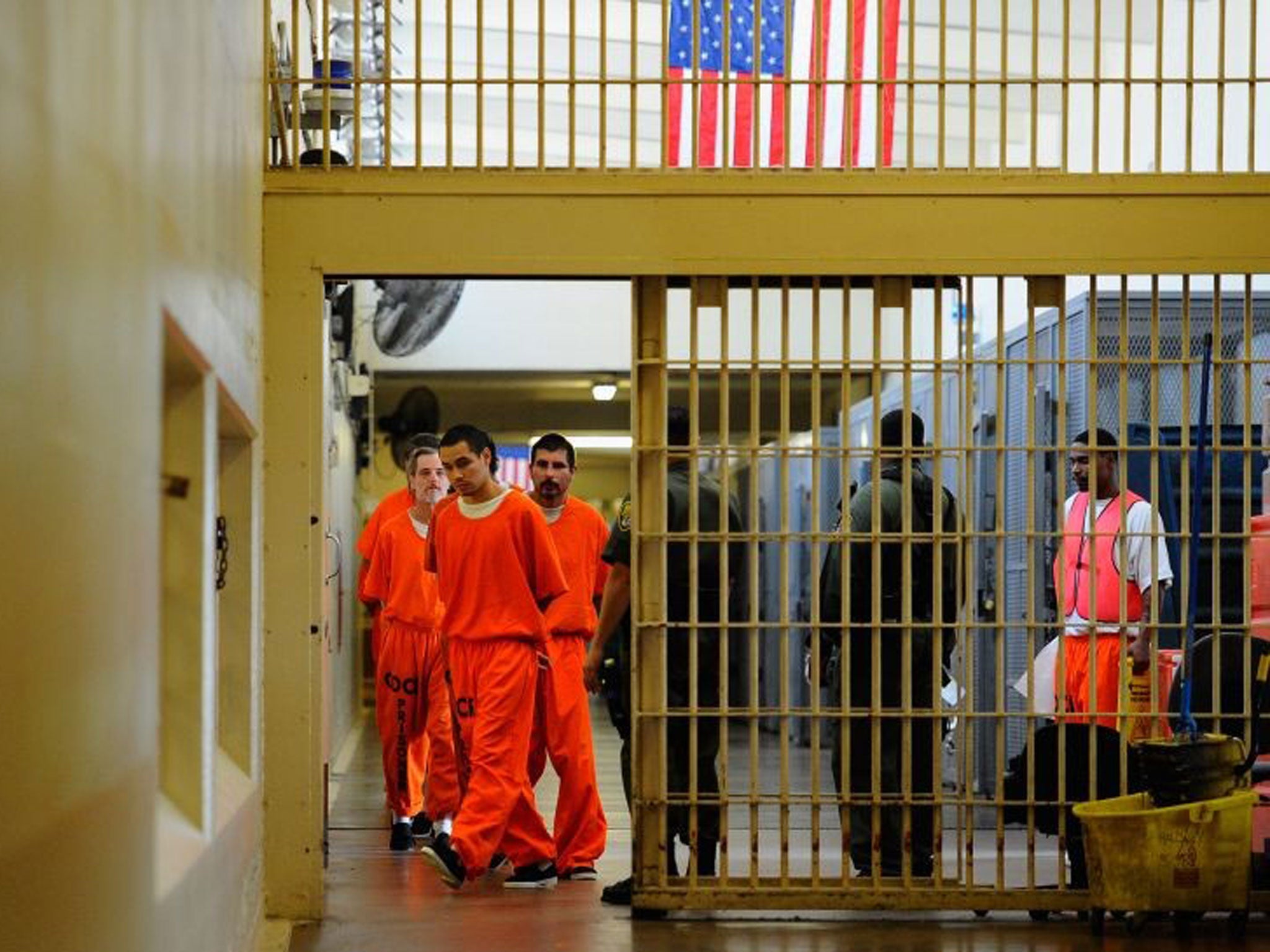 Inmates at Chino State Prison walk the hallway on December 10, 2010 in Chino, California.