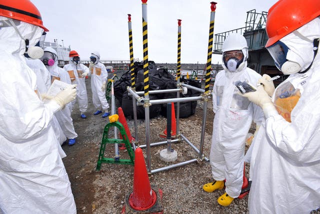 Local government officials and nuclear experts inspecting a monitoring well where high levels of radioactive materials were detected at Tokyo Electric Power's (TEPCO) Fukushima Dai-ichi nuclear plant