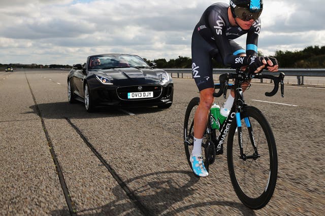 Man versus machine: Chris Froome tries a high-speed run on his Pinarello bike with a Jaguar F-Type in pursuit