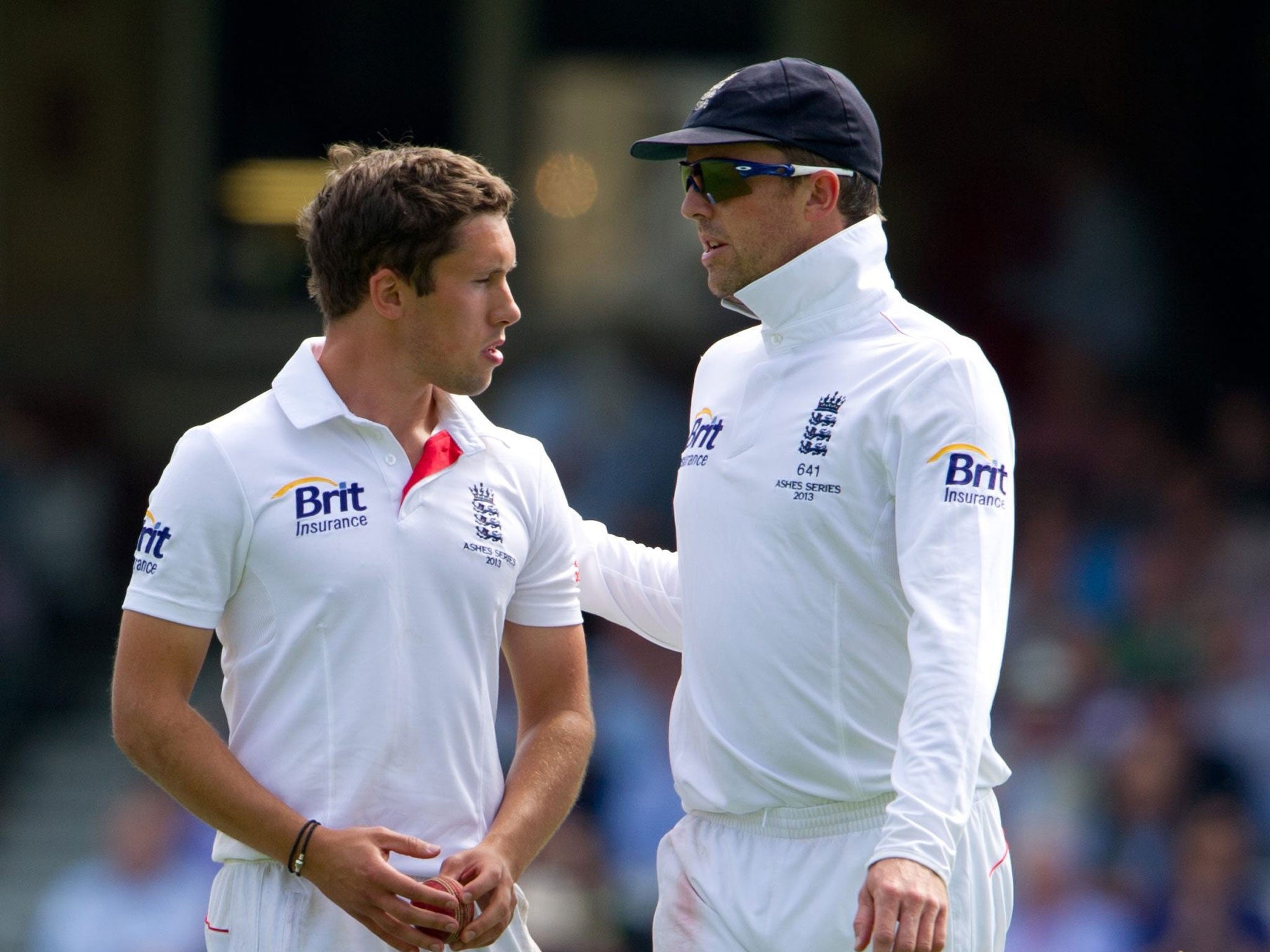 A shell-shocked Simon Kerrigan is comforted by England's senior spin bowler Graeme Swann