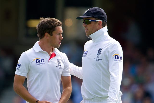A shell-shocked Simon Kerrigan is comforted by England's senior spin bowler Graeme Swann