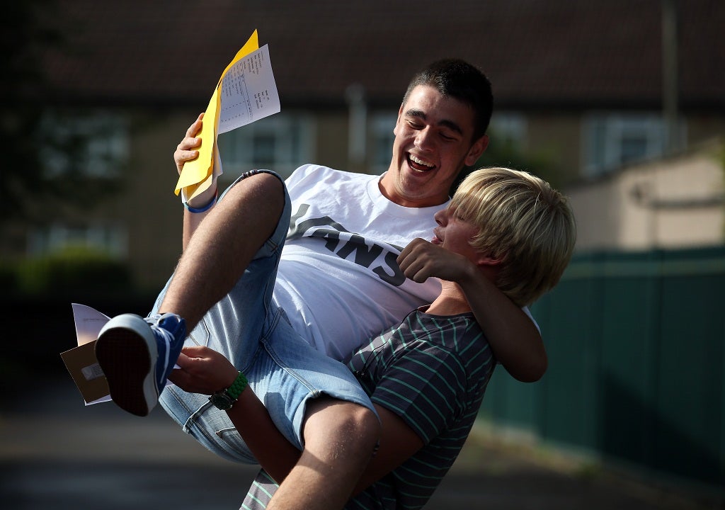 Joe Tindall lifts fellow student Halil Beydilli in celebration at great results.