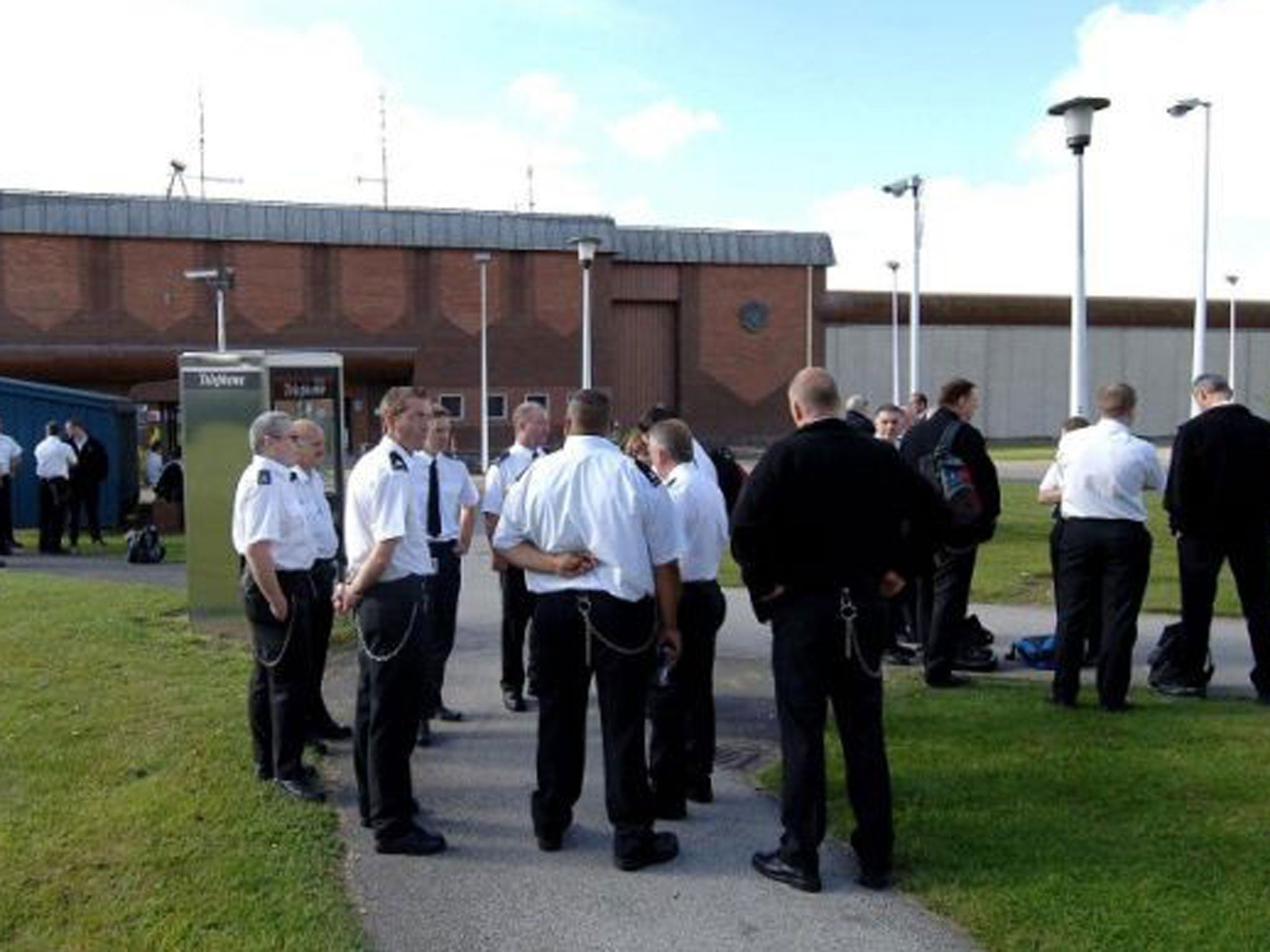 Staff outside Full Sutton prison in York where three serving prisoners, Feroz Khan, Fuad Awale and David Watson have been charged with falsely imprisoning an officer