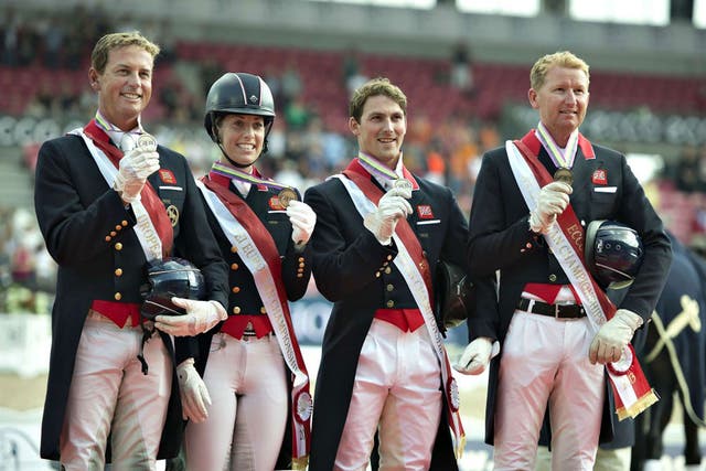 Dujardin, second from left, broke her own world best of 84.447 per cent