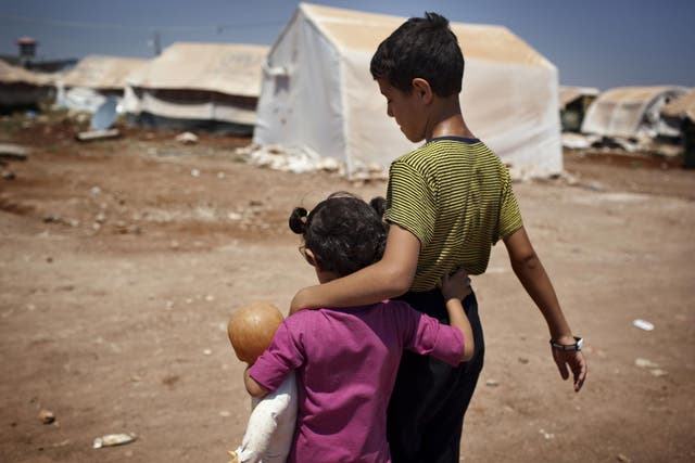 Syrian refugee children walk in the Bab al-Salam refugee camp in Syria's northern city of Azaz