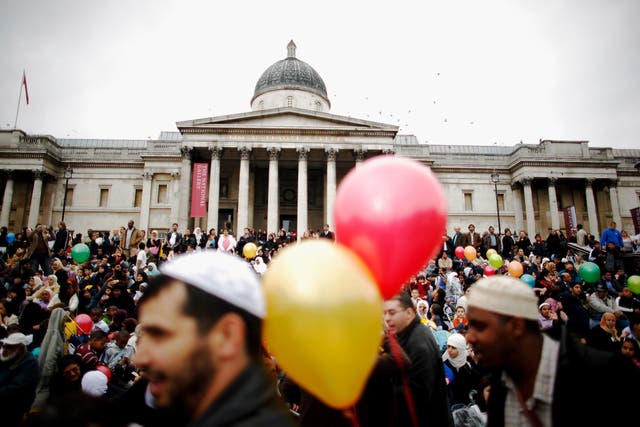 Muslims gather on the steps of Trafalgar Square to celebrate the end of Ramadan