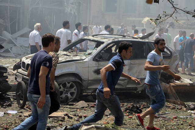 Lebanese citizens gather at the site of a powerful explosion in the northern Lebanese city of Tripoli
