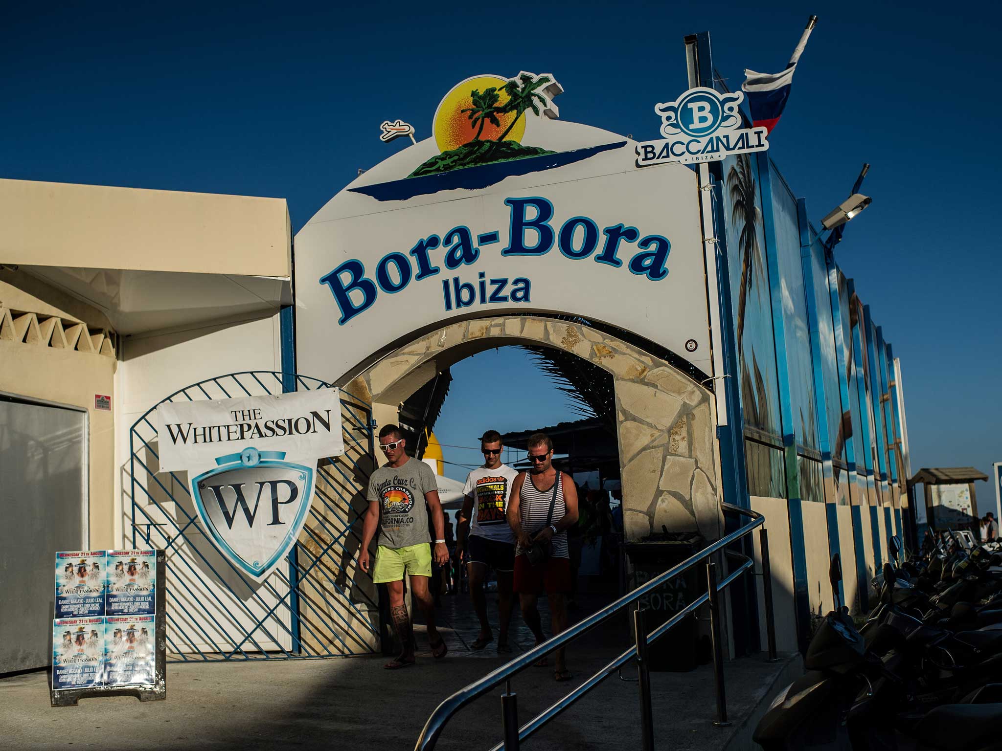 Tourists leave the Bora-Bora Bar at Playa d'en Bossa