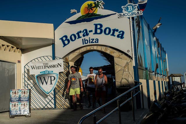 Tourists leave the Bora-Bora Bar at  Playa d'en Bossa